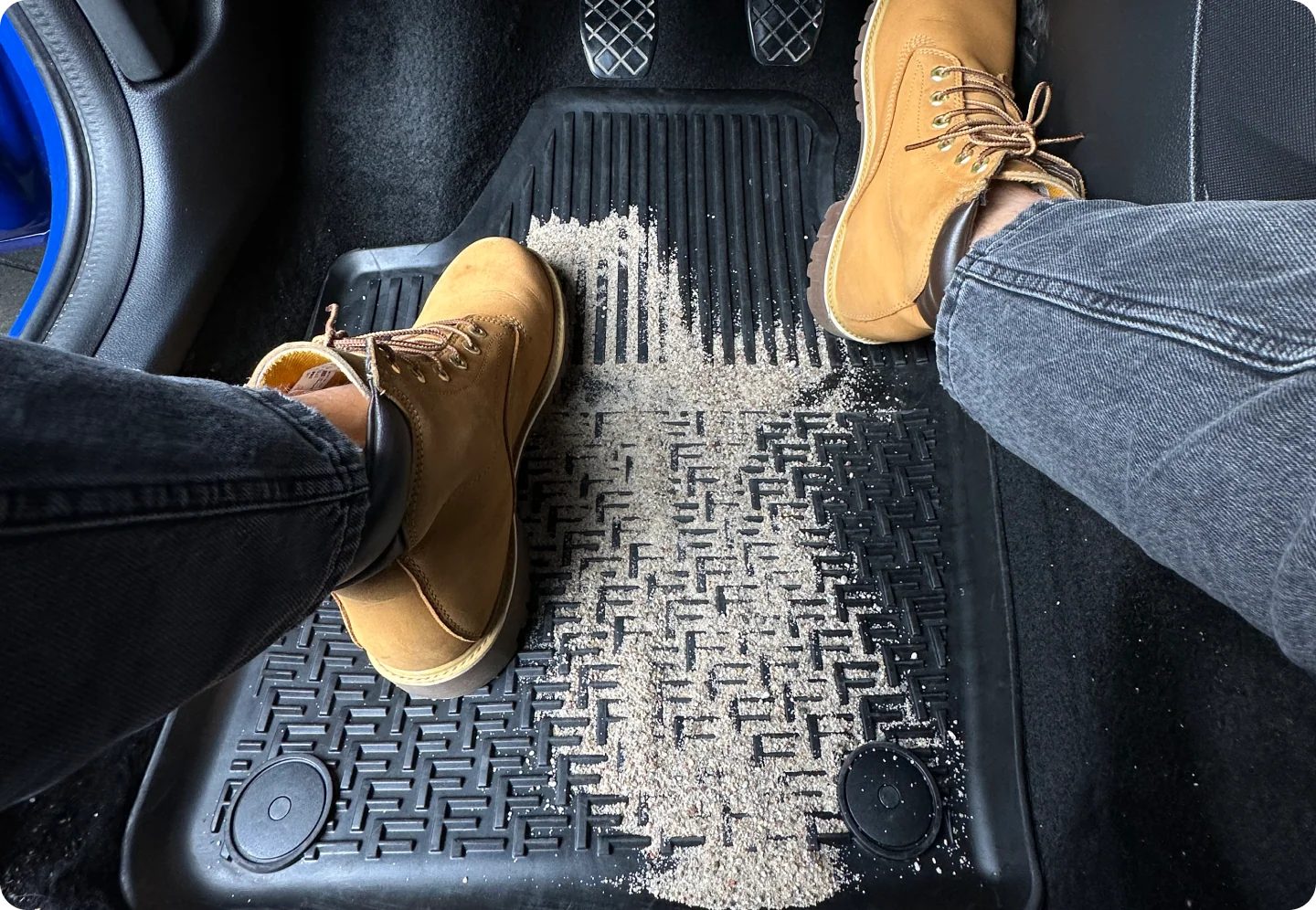 Dirty rubber car mat shown during everyday use